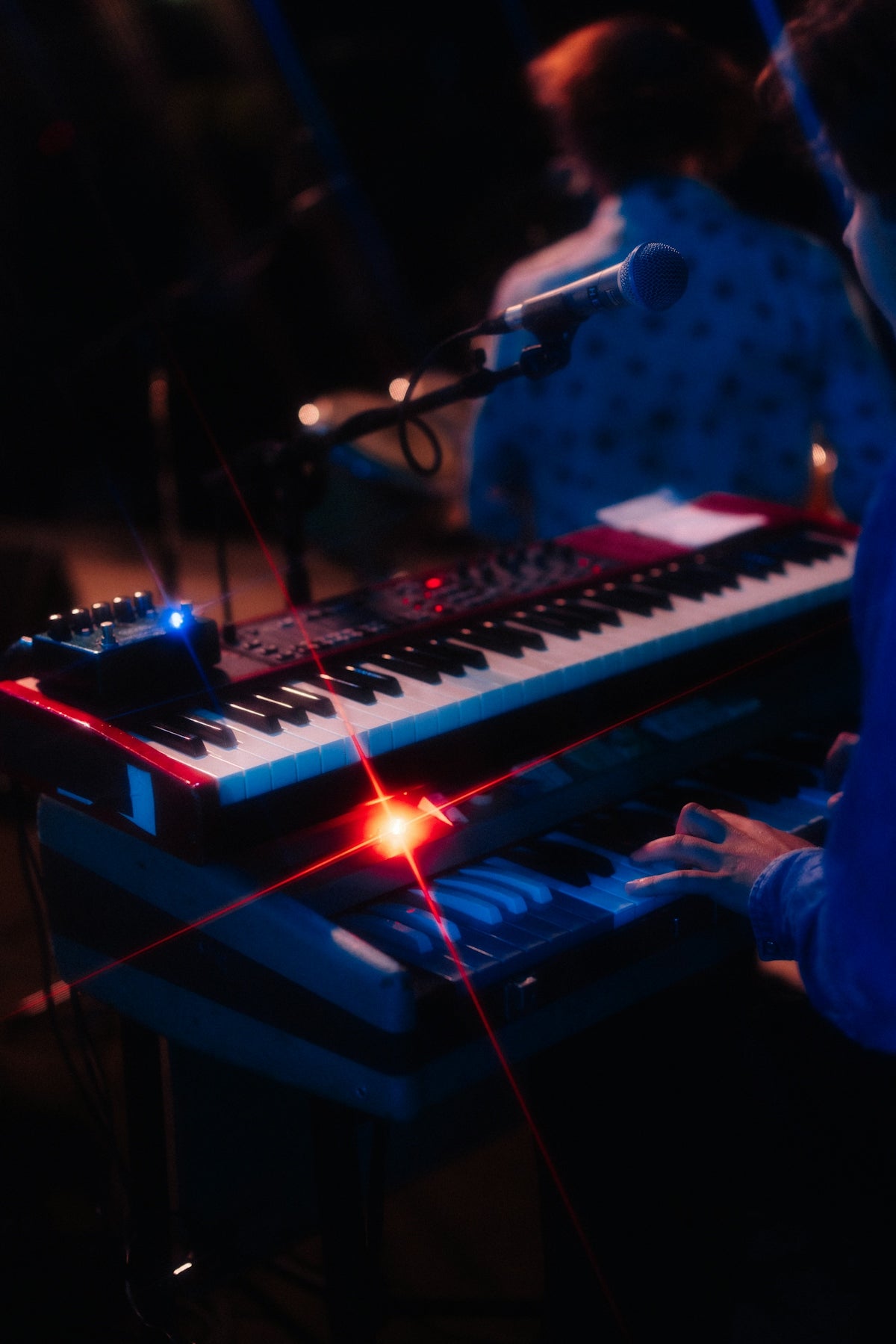 Musician playing a synthesizer on stage