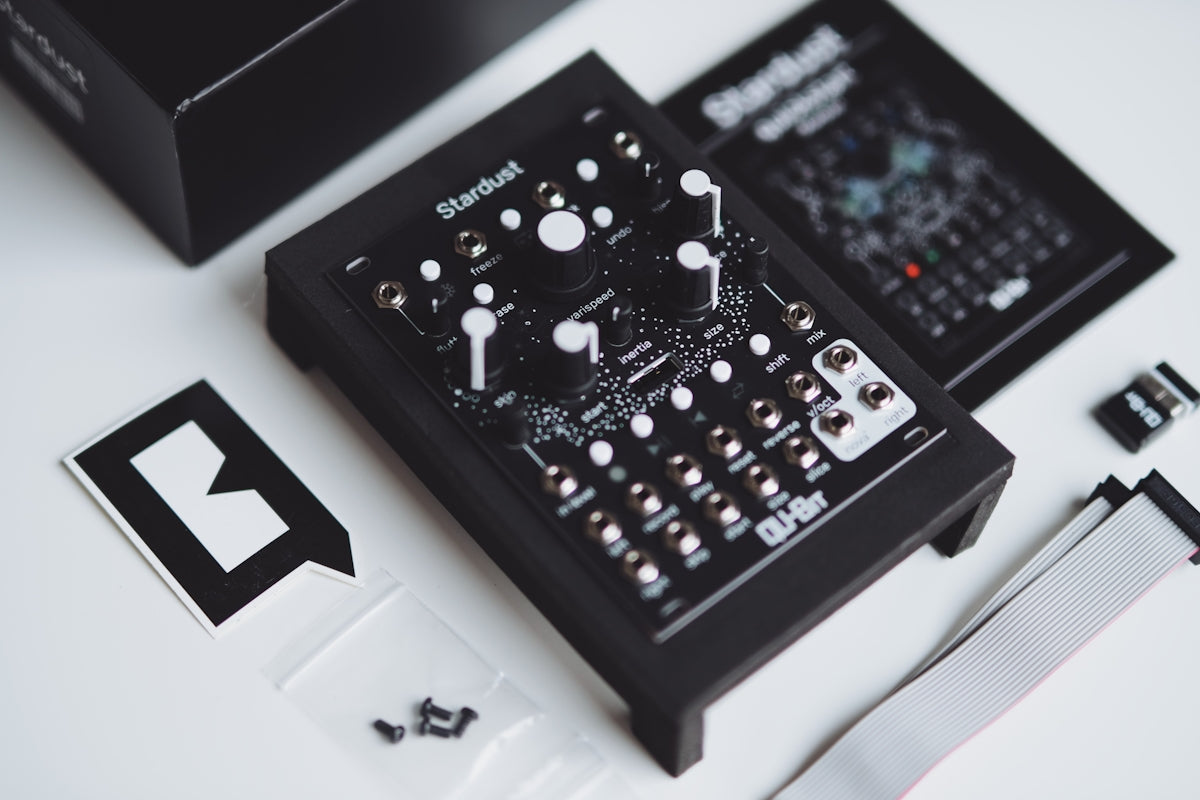 Black electronic music synthesizer with accessories on-screen controls.